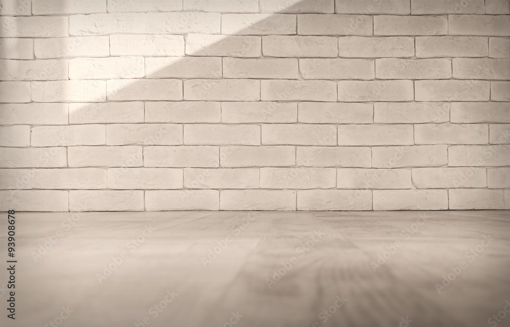 Fototapeta premium Brick wall background with light floor illuminated by natural sunlight shadow, creating a neutral beige texture and wooden surface stage for product display and mockup presentations