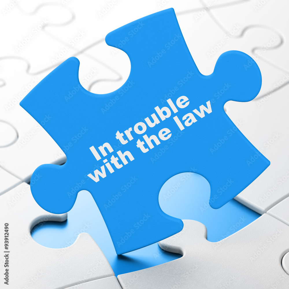 Law concept: In trouble With The law on puzzle background Law concept: In trouble With The law on puzzle background