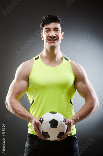 Muscular man with football ball © Elnur