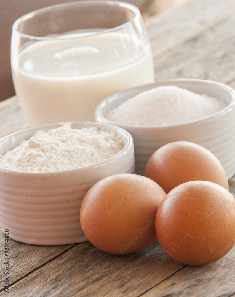 Ingredients for pancakes - eggs, flour, milk on wooden background. Ingredients for pancakes - eggs, flour, milk on wooden background.