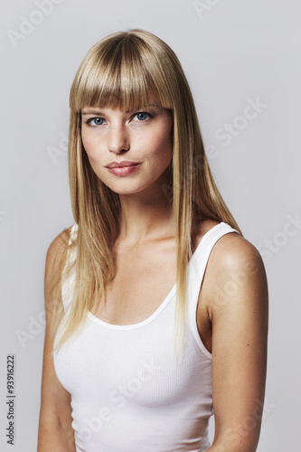 Pretty blond model in white vest, portrait