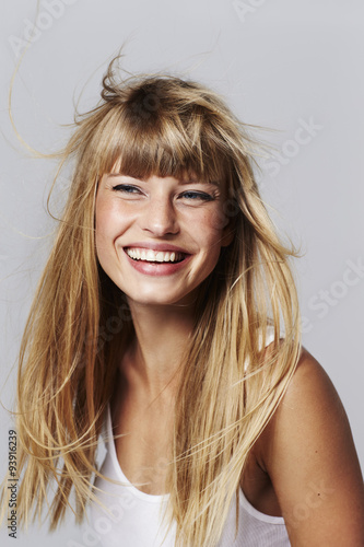 Young woman laughing in studio