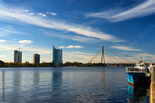 Blue boat on the River Daugava in the background of a suspension © victorgrow