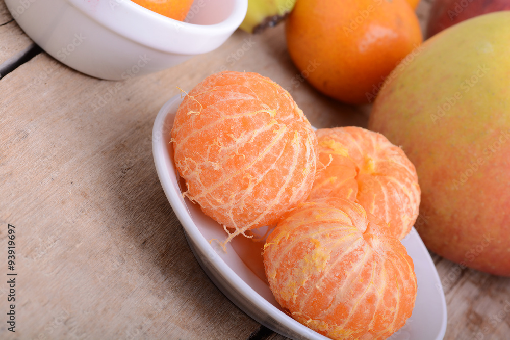 Bowls of slices mandarin with apple on rustic wooden background Bowls of slices mandarin with apple on rustic wooden background