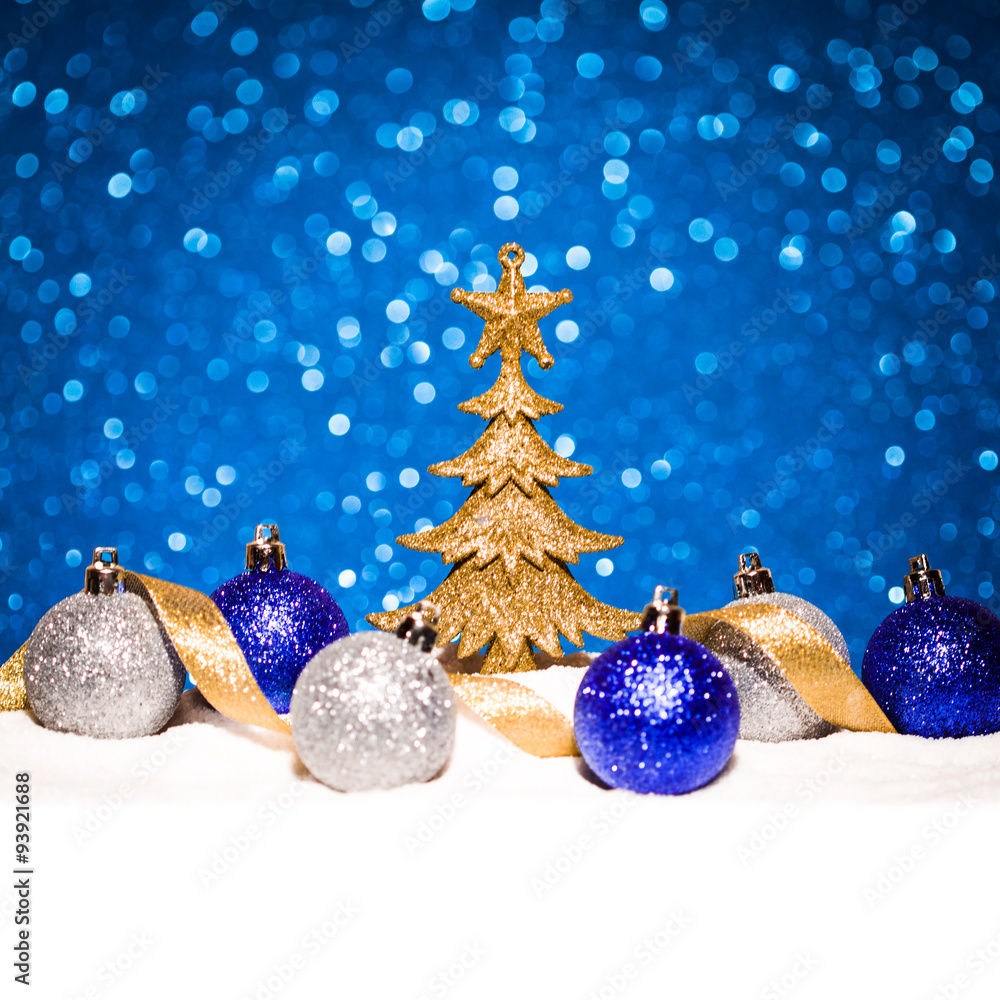 christmas ornament in snow on glitter background christmas ornament in snow on glitter background