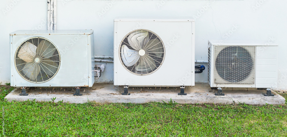 Fototapeta premium Three old air conditioner beside home