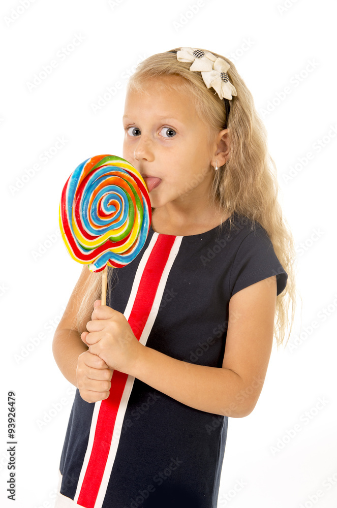 beautiful female child with long blond hair holding huge spiral lollipop candy smiling happy
