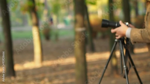 Photographer takes pictures with a tripod