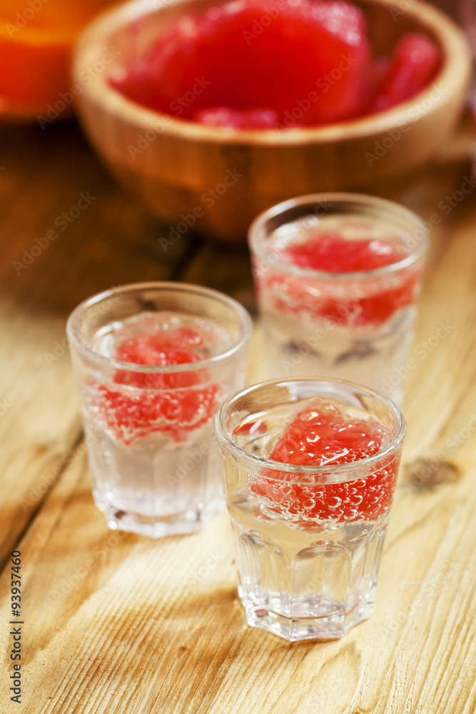Soda with pink grapefruit in glasses on an old wooden table, sel Soda with pink grapefruit in glasses on an old wooden table, sel