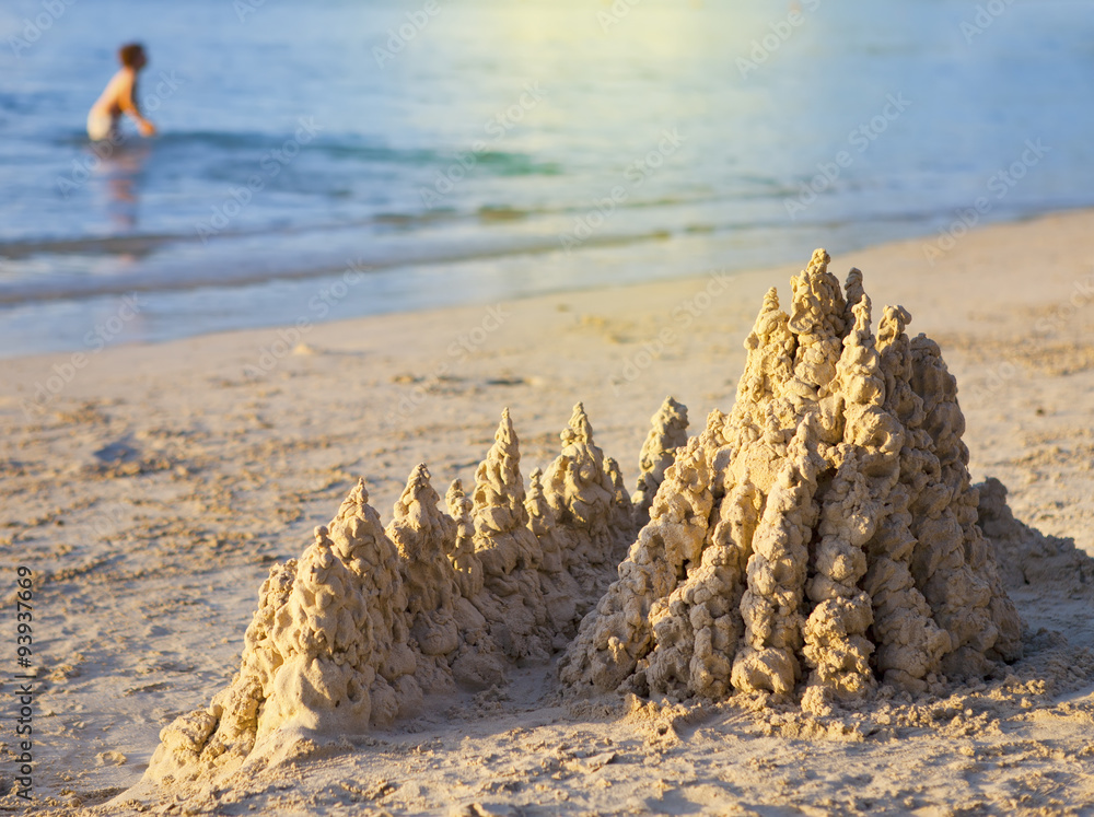 sandy castle at the sea edge