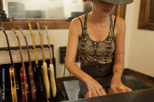 Young female musician playing a keyboard photo