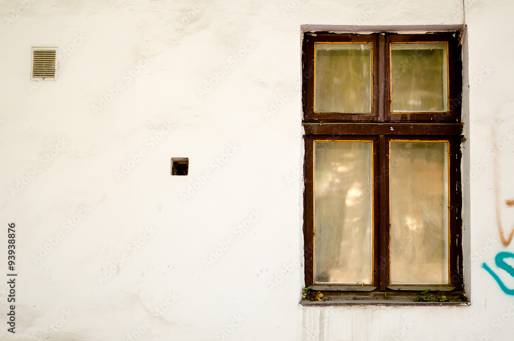 Old wooden windows frame on cement cracked wall