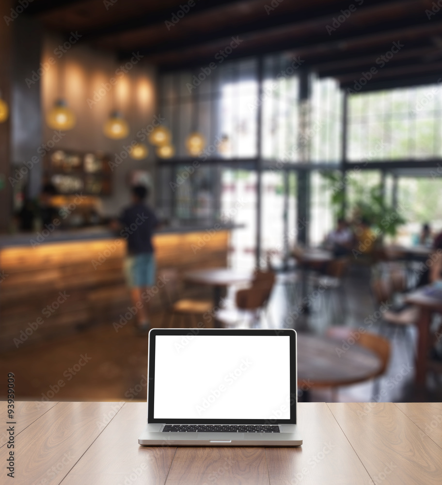 Blank screen laptop computer with blur coffee shop background Blank screen laptop computer with blur coffee shop background
