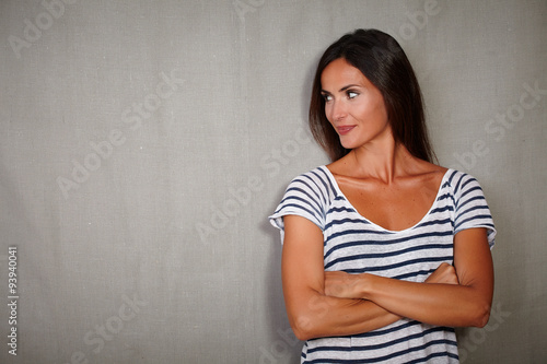 Brunette girl standing with arms crossed