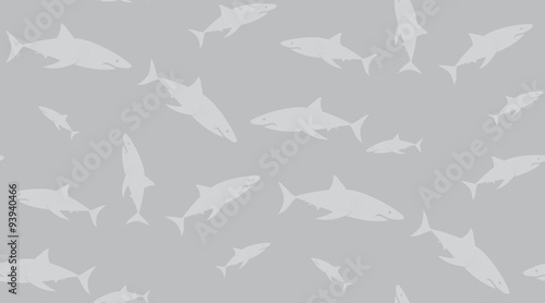 Vector seamless pattern of sharks. Sharks are located randomly on a gray background.