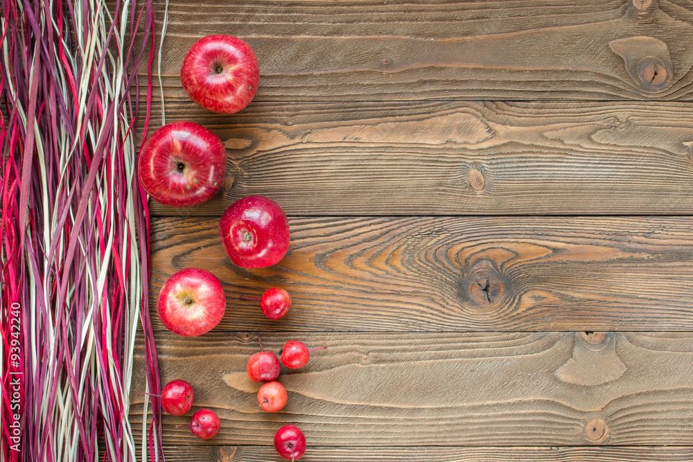 ripe red apples on wooden table with decorative colorful dry straw. top view. free space for text ripe red apples on wooden table with decorative colorful dry straw. top view. free space for text