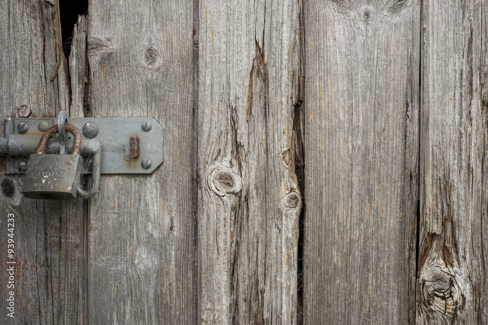 Old wooden door with a padlock