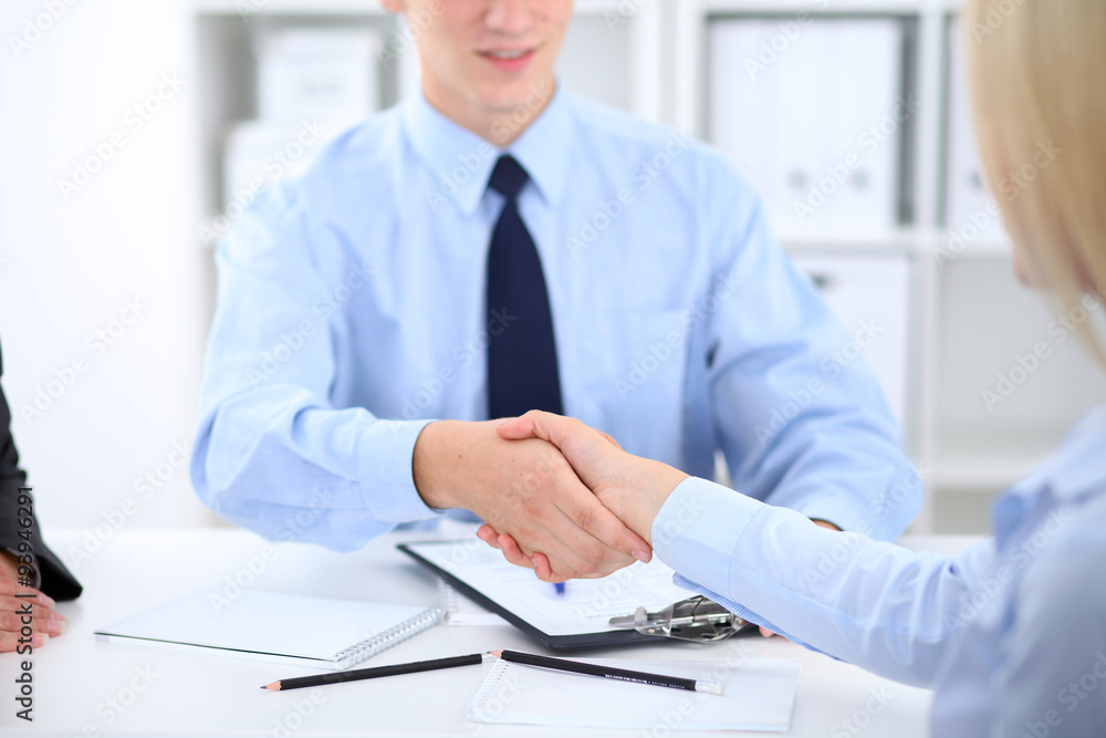 Business people shaking hands, finishing up a meeting Business people shaking hands, finishing up a meeting