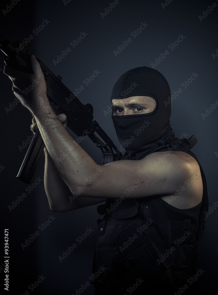 Outlaw, terrorist carrying a machine gun and balaclava Outlaw, terrorist carrying a machine gun and balaclava