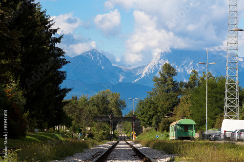 Railway going into the distance to the massive mountains. photo