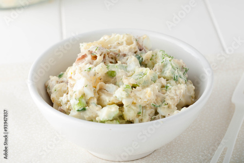 фотографія homemade potato salad made with red potatoes, celery sticks, red
