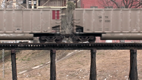 Train cars crossing wood bridge HD photo