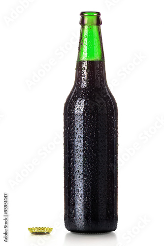 Bottle of beer with drops isolated on white