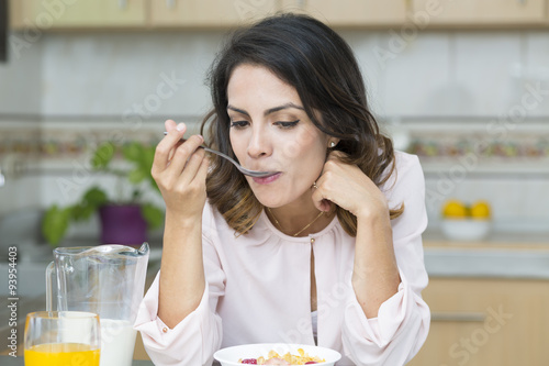 Attractive woman having breakfast