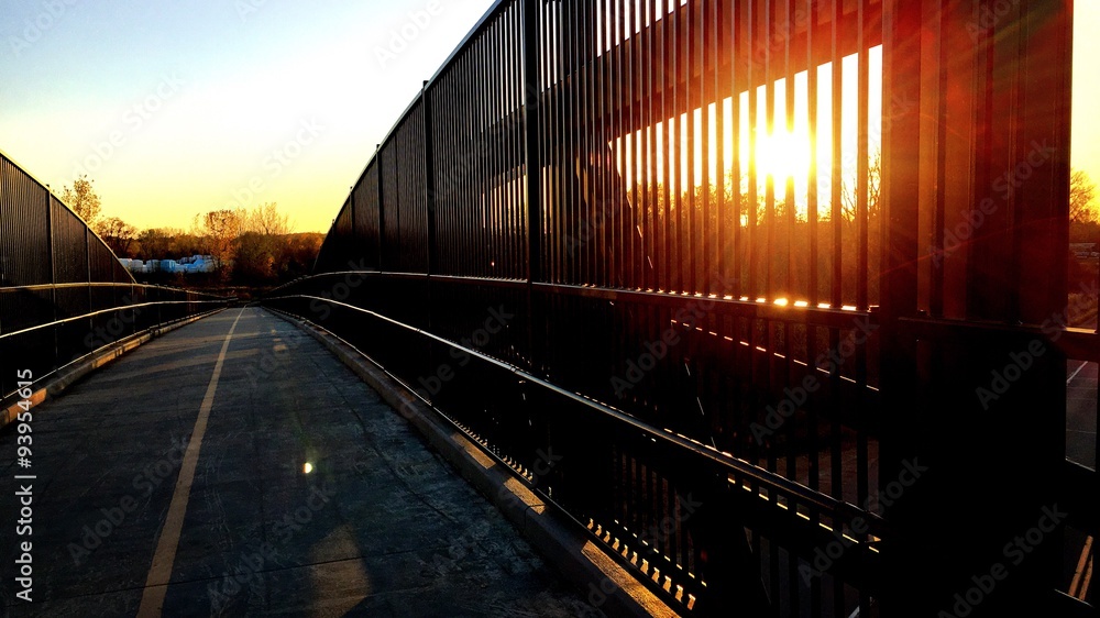 Sun rays breaking through the bridge railings