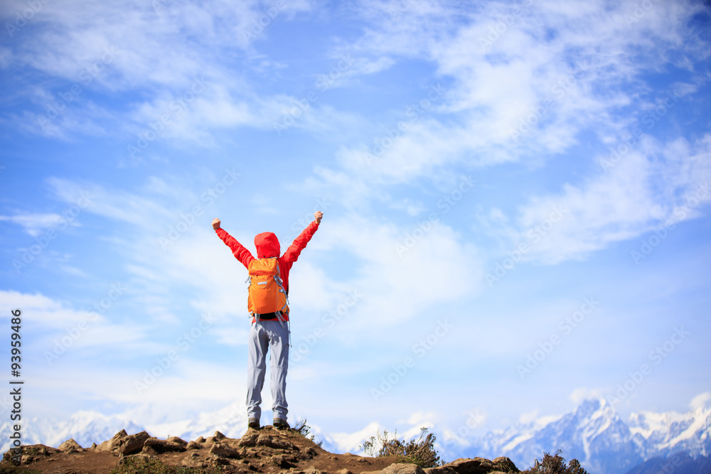 cheering young woman hiker open arms to beautiful snow mountain cheering young woman hiker open arms to beautiful snow mountain