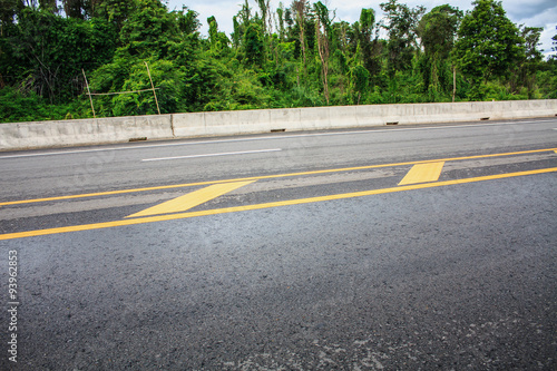 Asphalt road texture background with yellow dashed line