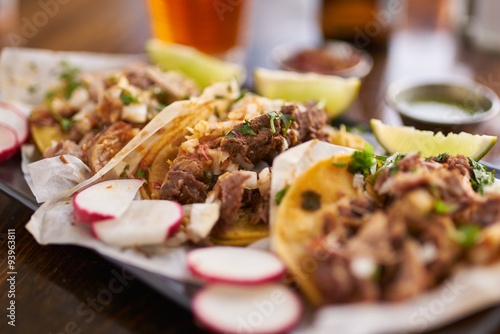 three authentic mexican street tacos with barbacoa, carnitas and chicken