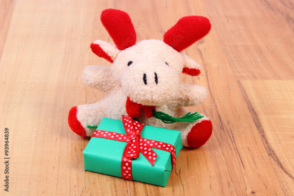 Fototapeta premium Plush reindeer with gift for Christmas or other celebration