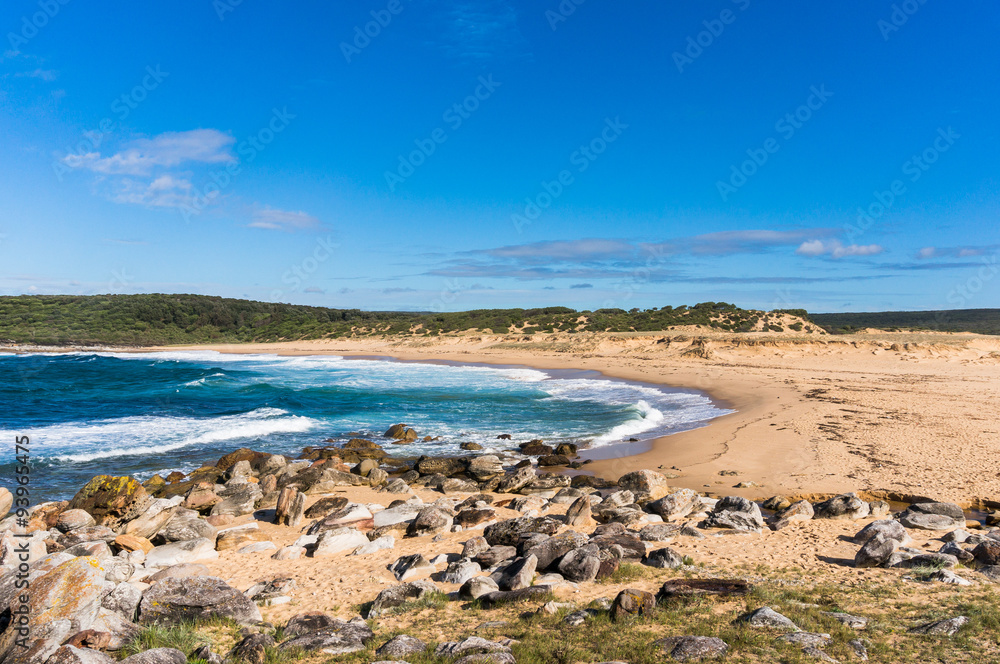 Picturesque secluded Australian ocean beach with rocky shore