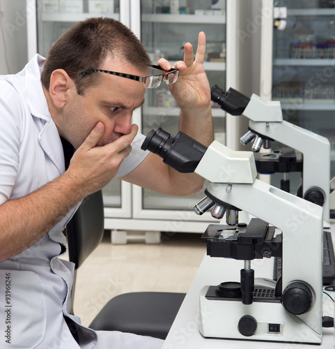Man working with a microscope in Laboratory