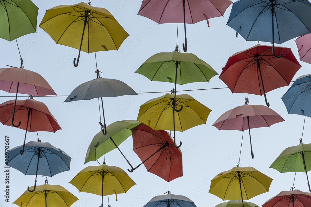 Hanging Multicoloured umbrellas over blue sky Colourful umbrellas urban street decoration