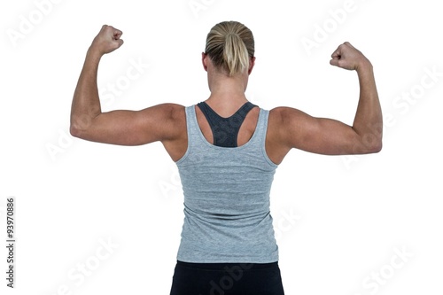 Rear view of muscular woman flexing muscles 