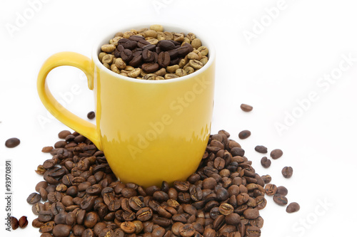 selective focus of coffee bean in yellow cup on white background