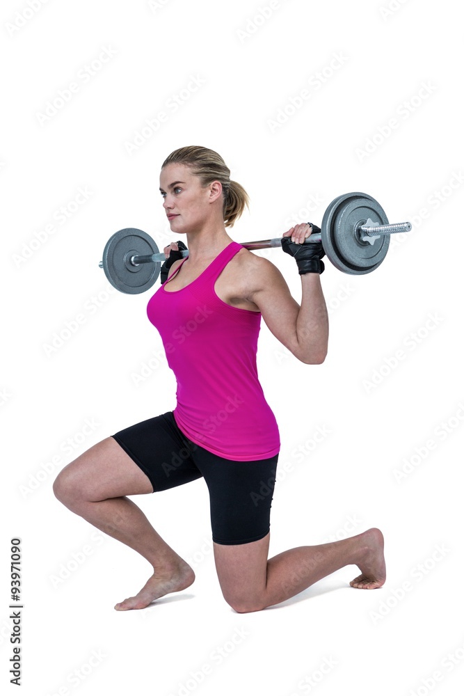 Obraz premium Sporty female bodybuilder lifting barebell