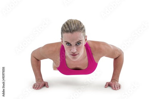 Portrait of pretty woman doing push ups