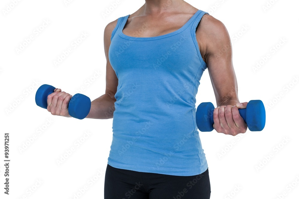 Muscular woman exercising with dumbbells Muscular woman exercising with dumbbells