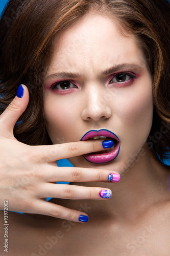 Beautiful model girl with bright makeup and colored  nail polish