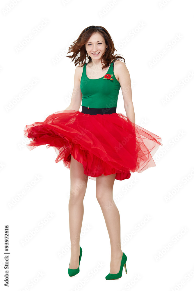 Dancing girl wearing retro skirt isolated on white background. Beautiful brunette young woman jumping in high heels Dancing girl wearing retro skirt isolated on white background. Beautiful brunette young woman jumping in high heels