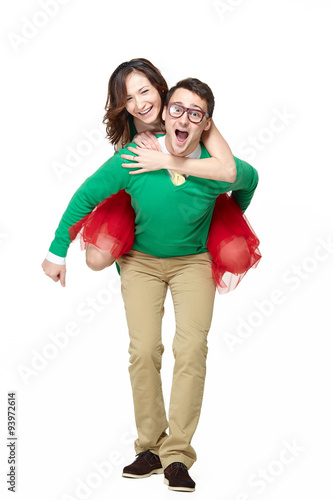 Happy young nerds couple. Piggybacking girl on her weird boyfriend isolated on white backgorund