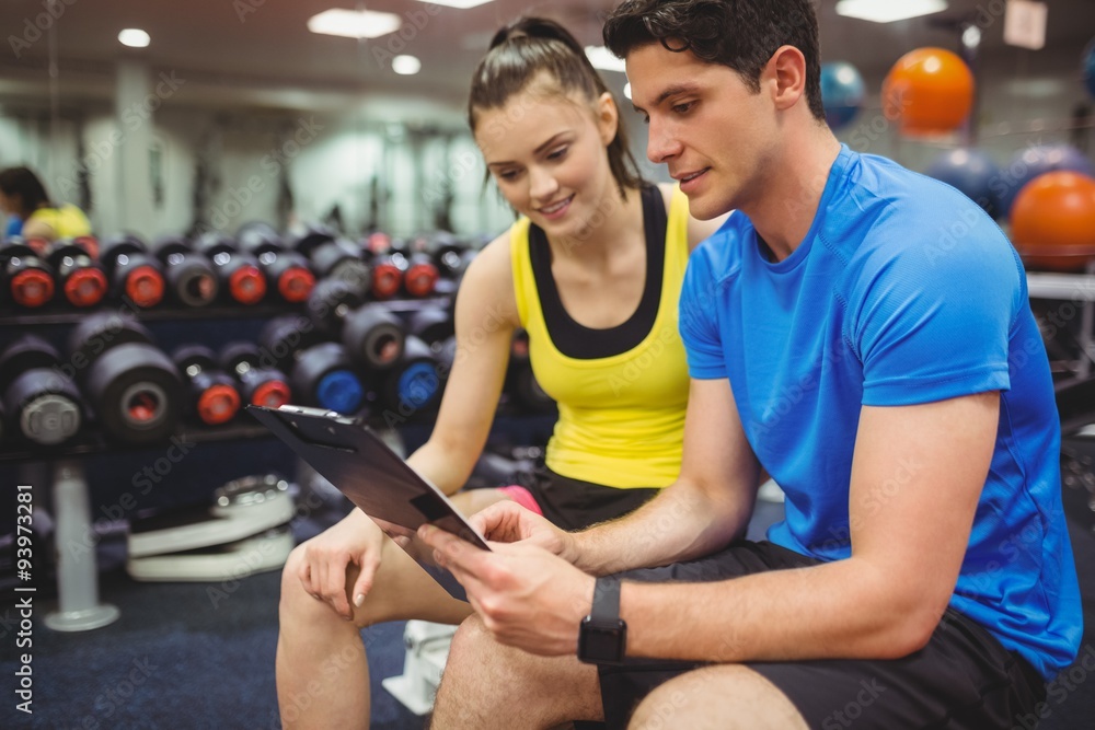 Trainer and client discussing her progress Trainer and client discussing her progress