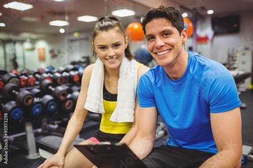 Trainer and client discussing her progress