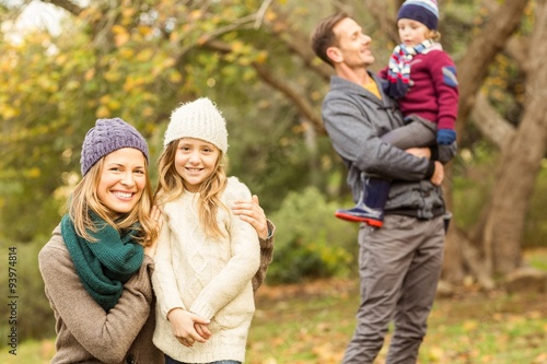 Smiling woman with her daughter against her husband and her son