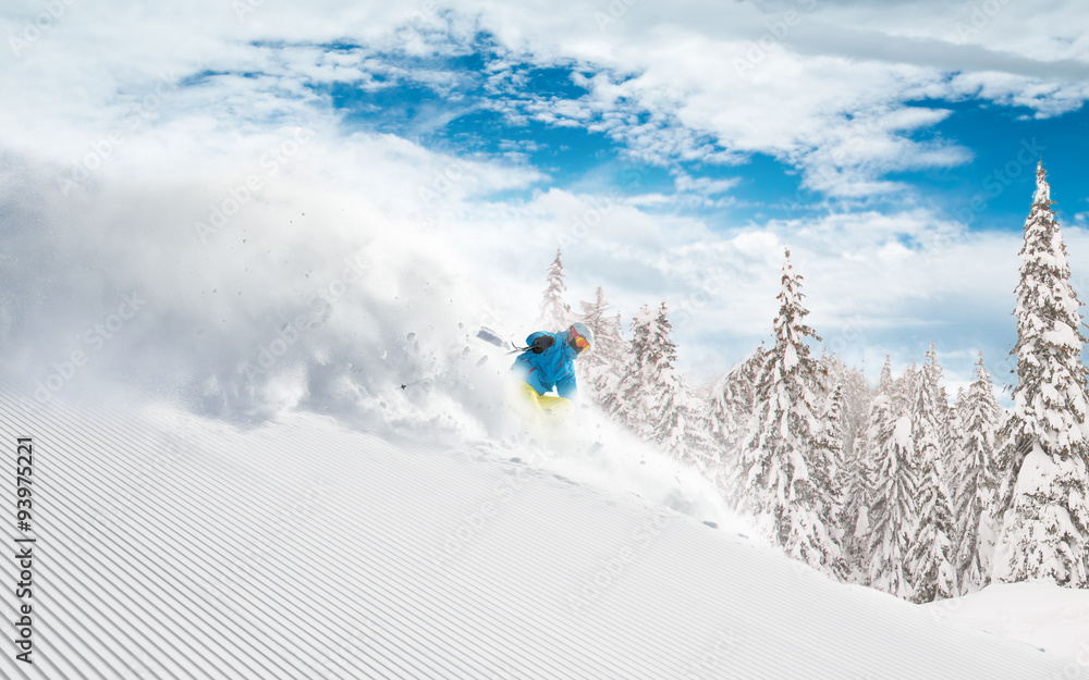 Skier skiing downhill in high mountains