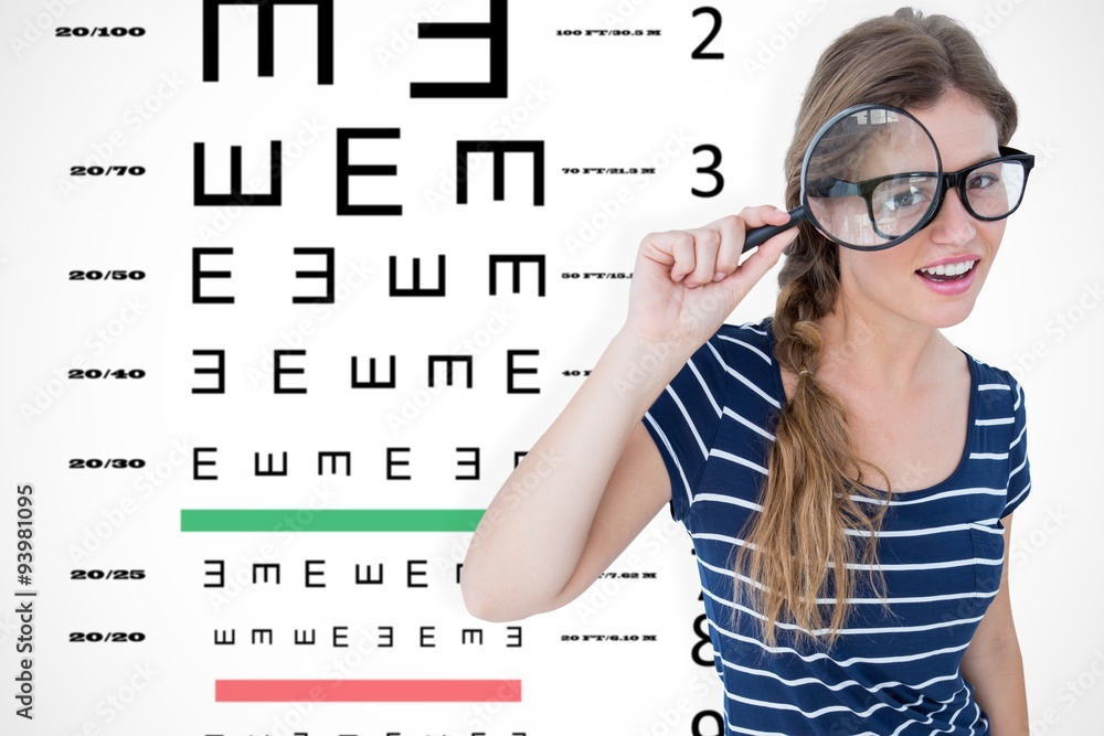 Composite image of smiling woman holding magnifying glass Composite image of smiling woman holding magnifying glass