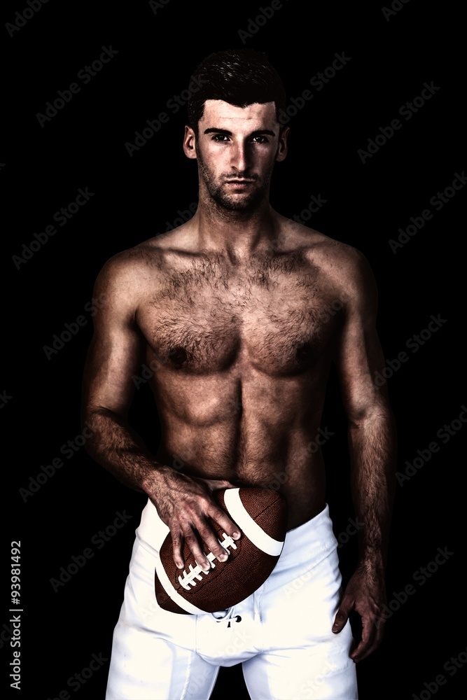 Fototapeta premium Composite image of portrait of a shirtless man holding ball